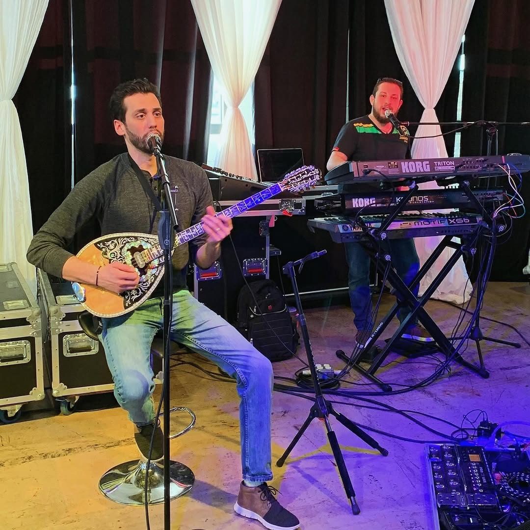 Oneiro musician playing bouzouki on stage