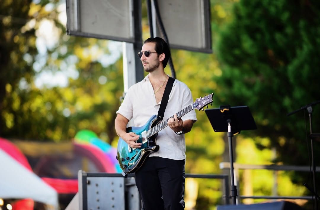 Oneiro guitarist performing live outdoors